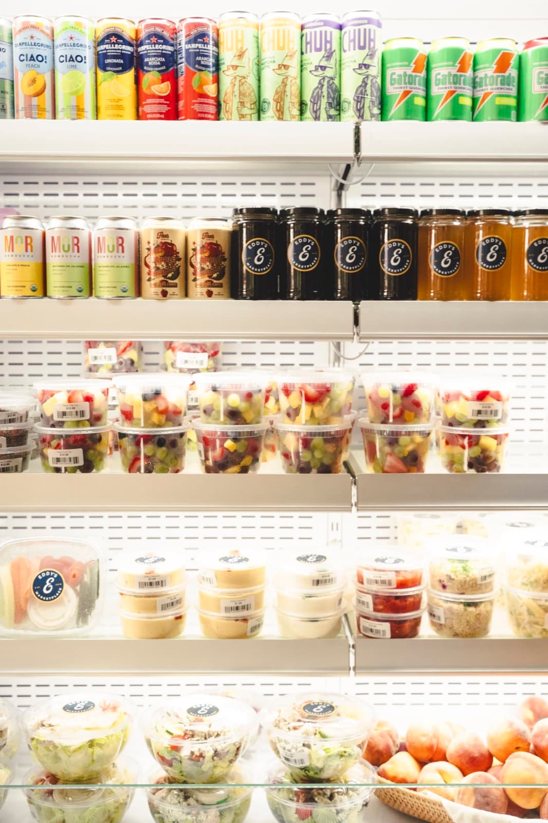 Grab-and-go cooler at Eddy's Marketplace stocked with drinks, salads, and Eddy's-branded goods