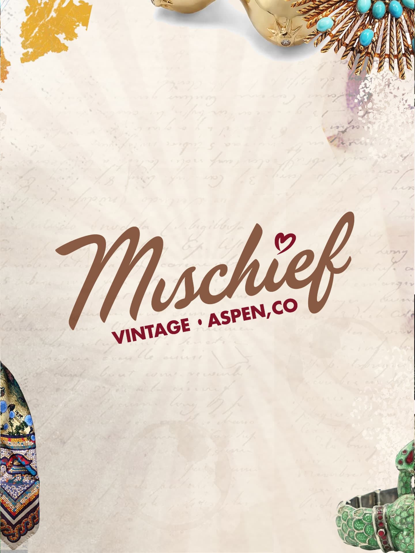 The Mischief Vintage logo on a vintage paper backdrop with curated jewelry