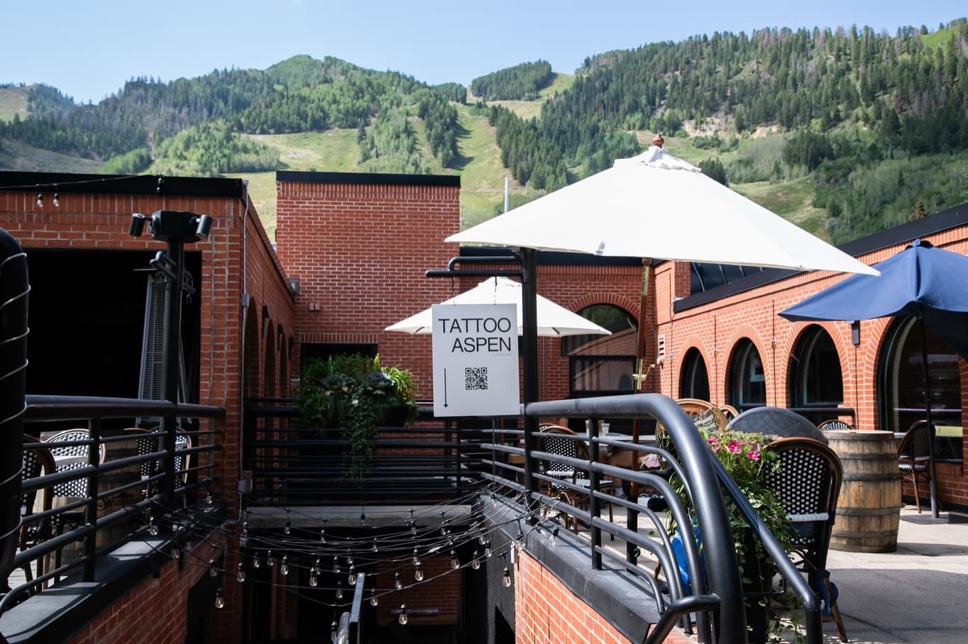 The Tattoo Aspen sign hanging in the courtyard at 315 E. Hyman Ave